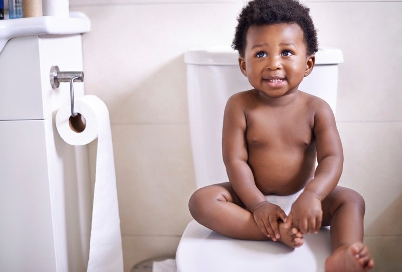 content child sitting in a bathroom 