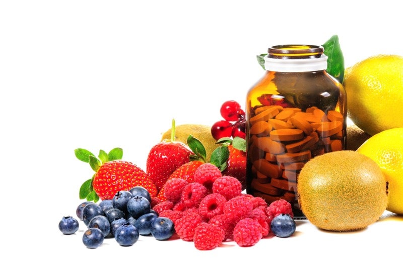Fruit and a bottle of pills
