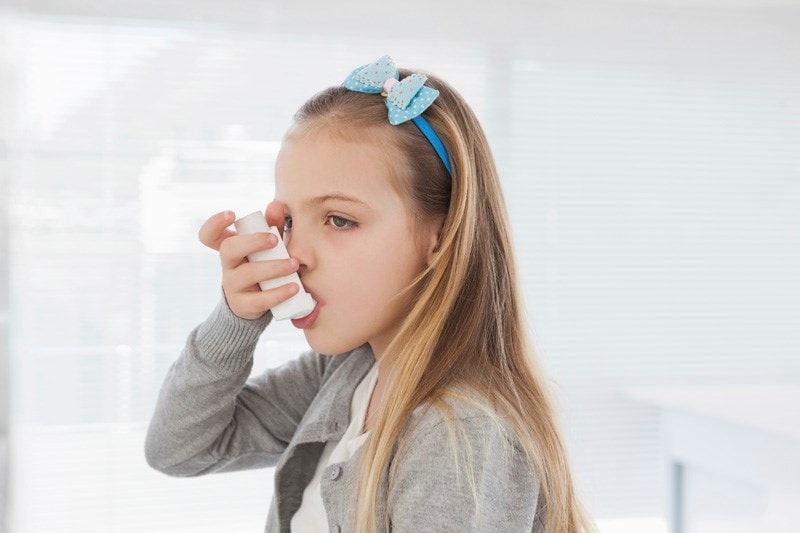 girl taking inhaler
