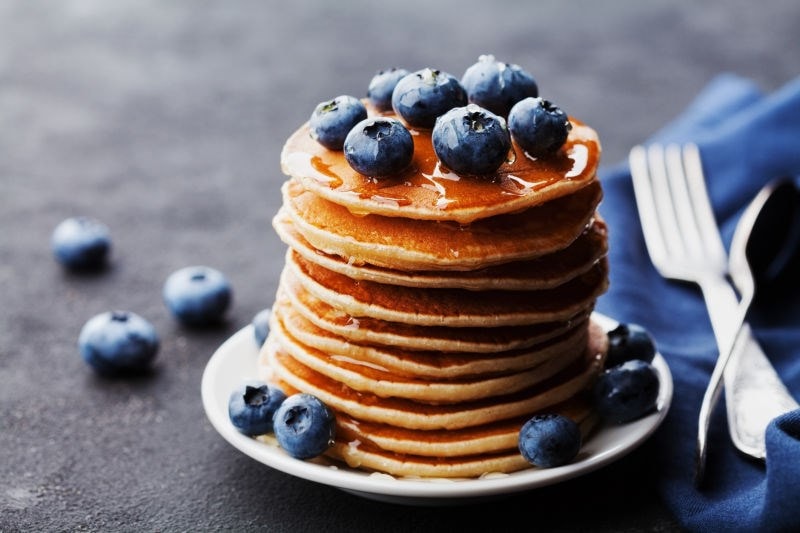 stacked pancakes and fruit 
