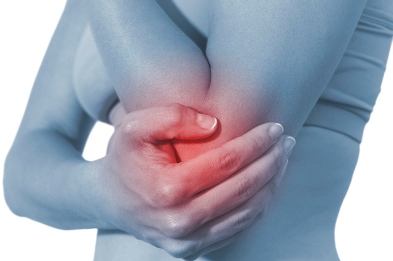 person holding their inflamed elbow