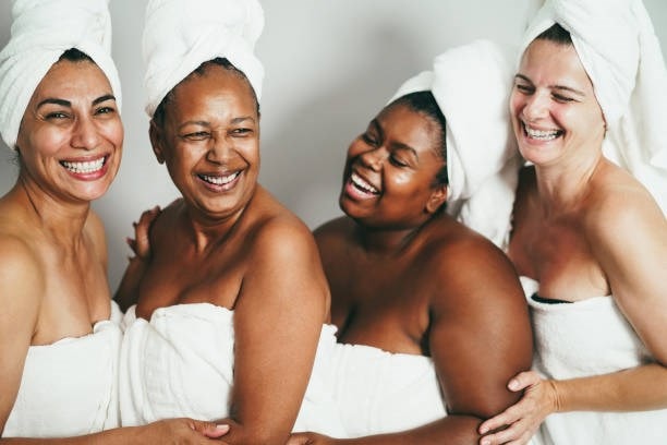 Four women laughing and cuddling 