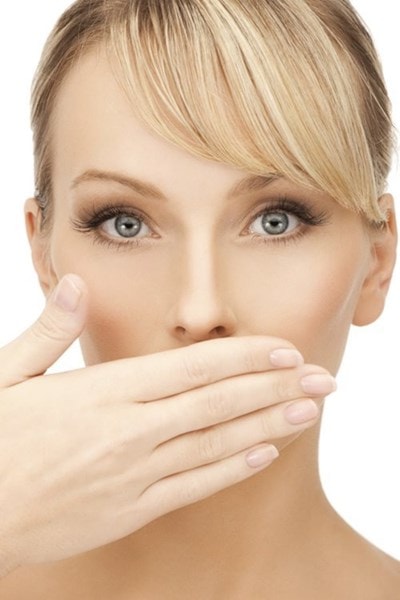 women covering mouth with hand 