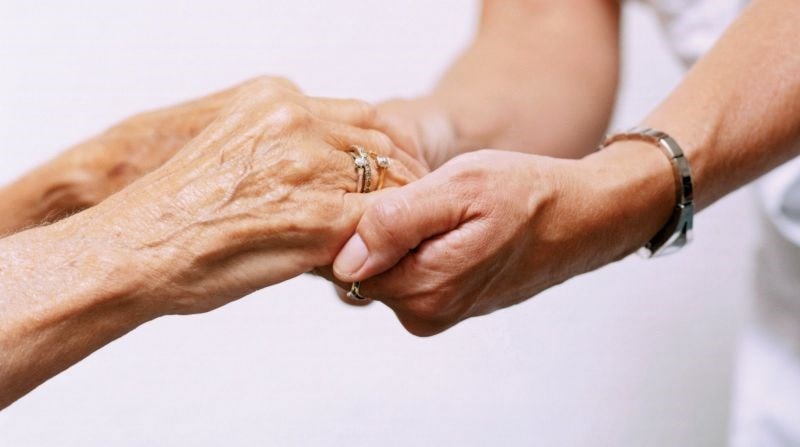 elderly holding hands
