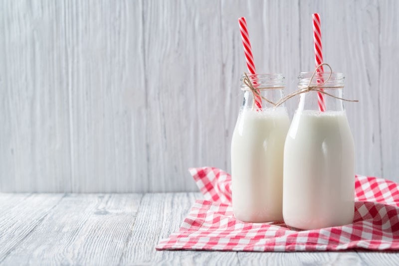 milk in drinking glass with straw