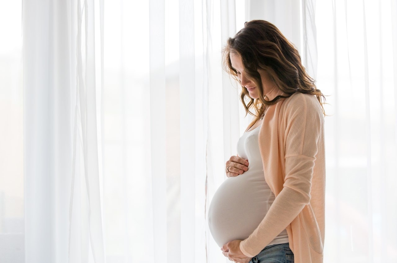 Women holding pregnant tummy