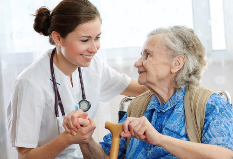 doctor holding elderly patients hand 