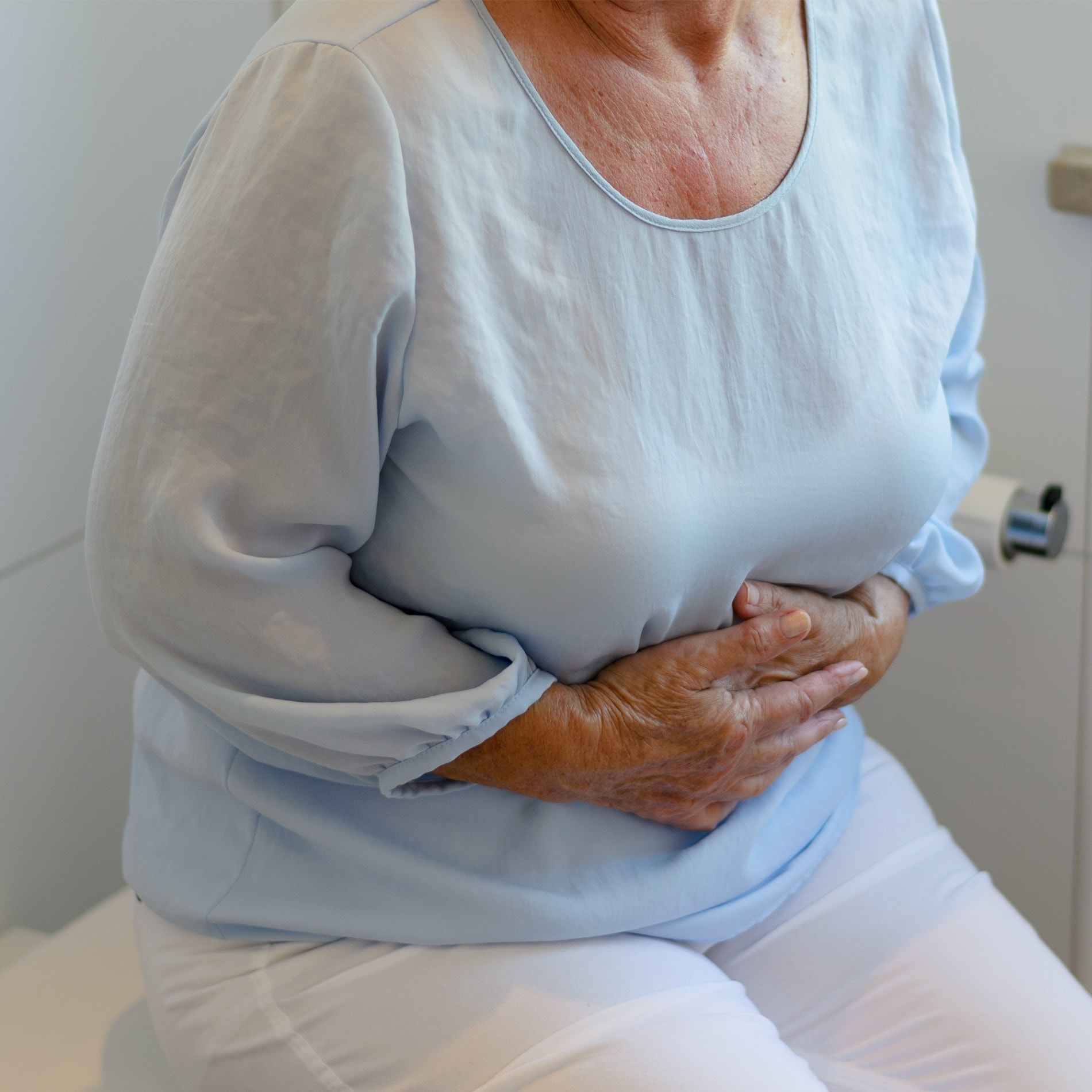 elderly woman holding her tummy